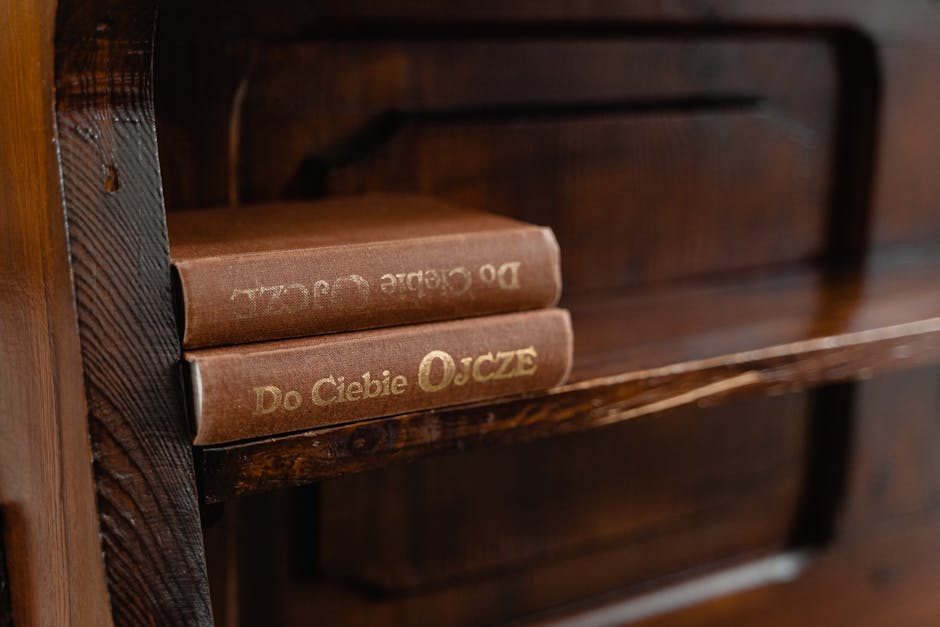 A cozy rustic wooden shelf displaying vintage books with gold embossed titles.
