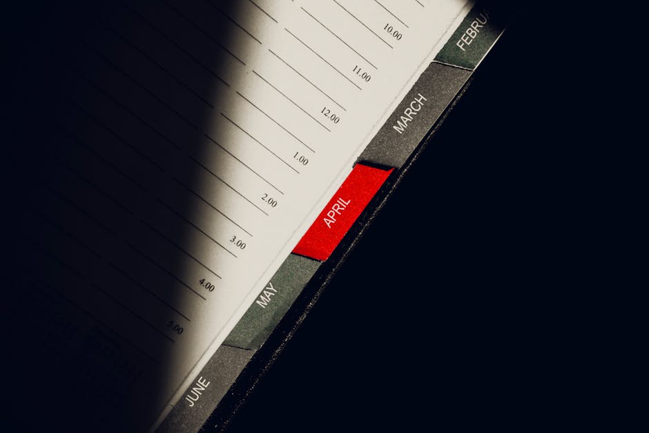 A close-up shot of a planner highlighting the month of April with visible monthly tabs.